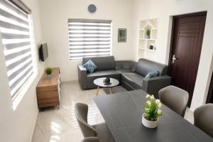 a living room with a couch and a table at Sidra Apartments - Spacious 2BHK Family Stay in Nilgiris, Pandalur, Tamil Nadu in Pandalūr
