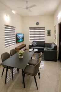 a living room with a table and a couch at Sidra Apartments - Spacious 2BHK Family Stay in Nilgiris, Pandalur, Tamil Nadu in Pandalūr +30 photos