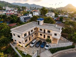 an aerial view of a house with cars parked in front at Sidra Apartments - Spacious 2BHK Family Stay in Nilgiris, Pandalur, Tamil Nadu in Pandalūr