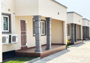 a building with columns on the side of it at Sofies's Apartments in Lusaka
