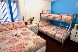 a bedroom with two bunk beds and a couch at blackpool central lodge And Rooms in Blackpool