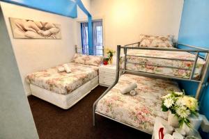 a bedroom with two bunk beds with flowers at blackpool central lodge And Rooms in Blackpool