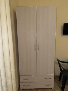a white cabinet in a room with a curtain at Blue Shore in Golem