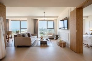 a living room with a couch and a table at Leonardo Plaza Ashdod in Ashdod