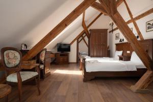 a bedroom with a bed and a tv in a attic at Casa Chitic Hotels in Braşov