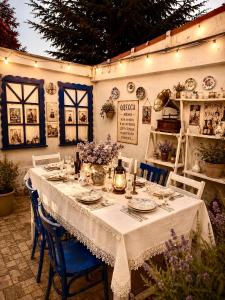 a table with a white table cloth and blue chairs at Parasolka in Odesa