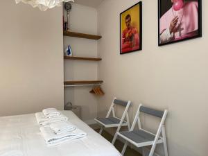 a dining room with two chairs and a table at Piso Bonaire in Sitges