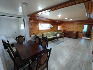 a living room with a table and chairs and a couch at Entire 4th Floor for Guests in Batumi