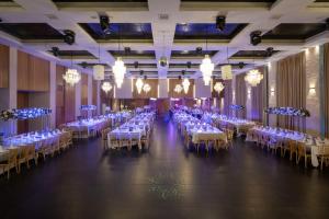 a banquet hall with white tables and chairs at Leonardo Plaza Ashdod in Ashdod +68 photos