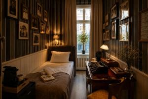 a bedroom with a bed and a desk and a window at Urban Budget Hotel- Unique Boutique Hotel on Best Location in Vienna