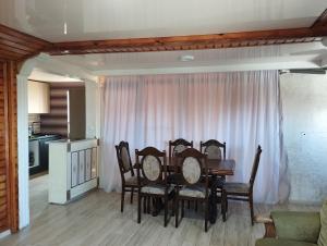 a dining room table and chairs in a room at Entire 4th Floor for Guests in Batumi +6 photos