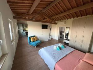 a bedroom with a bed and a blue chair at Casa vacanze Conca d Oro in SantʼAmbrogio di Valpolicella +61 photos