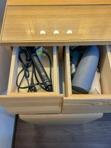 a wooden cabinet with some items in it at COMMA House 川崎 in Kawasaki