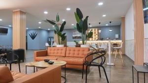 a living room with a couch and a table at Hotel Aloe Emira NKC in Nouakchott