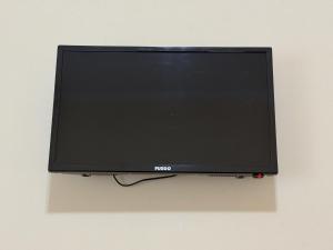 a flat screen tv hanging on a wall at Blue Shore in Golem