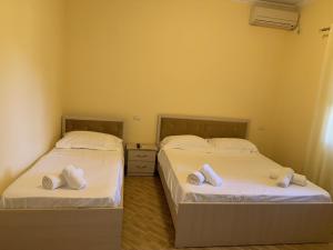 two beds sitting next to each other in a room at Blue Shore in Golem +7 photos