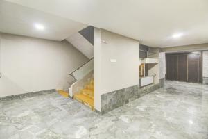 an empty room with stairs and a stair case at Hotel O New Pride in Sāngli