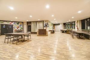 an empty room with tables and chairs in it at Hotel O New Pride in Sāngli