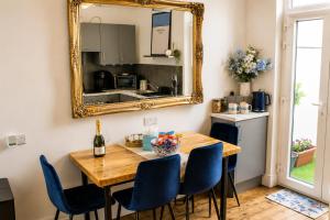 a dining room with a table and a mirror at Lavina by the sea in Bangor