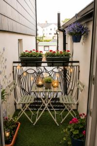 a balcony with flowers and plants on a table at Lavina by the sea in Bangor