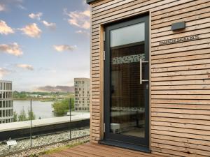 a glass door on a building with a view of a river at ScanHotels Stadthafen in Rostock