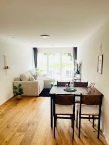 a living room with a table and a couch at Appartement "Suite Seeliebe" in Tägerwilen