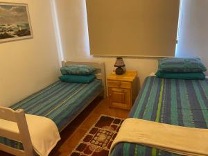 a bedroom with two beds and a night stand at lagoon value ! in Langebaan