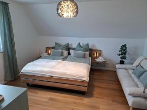a bedroom with a bed and a couch at Ferienhaus Zerbst in Zerbst +29 photos
