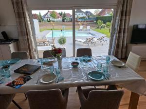 a dining room table with a view of a pool at Ferienhaus Zerbst in Zerbst