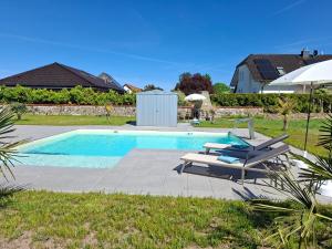 a swimming pool with a chaise lounge and a swimming pool at Ferienhaus Zerbst in Zerbst
