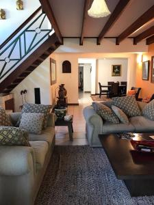 a large living room with couches and a dining room at Executive Serviced Home in Johannesburg