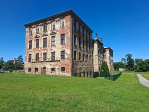 an old brick building with a christmas tree in a field at Ferienhaus Zerbst in Zerbst