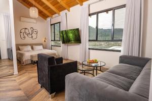 a living room with a couch and a bed at עיינות ספיר - Einot Sapir in Sappir +45 photos