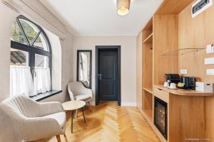 a living room with two chairs and a fireplace at Dokia Boutique in Gura Humorului