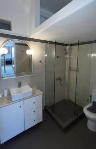 a bathroom with a shower and a sink and a toilet at Rosalie Home - Open Sea Duo in Tinos +9 photos