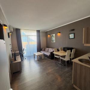 a living room with a couch and a table at Selfie in Batumi