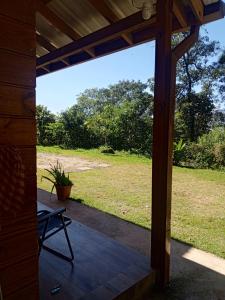 a screened porch with a view of a field at Chalé da Montanha in São Roque