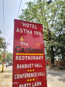 a red hotel ashtar inn sign on the side of a street at Hotel ashtha inn in Gaya