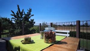 a table with a jar of donuts on a table with a cup at Casa Rifugio Parma in Basilicanova