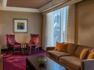 a living room with a couch and chairs and a large window at Fairmont Austin in Austin