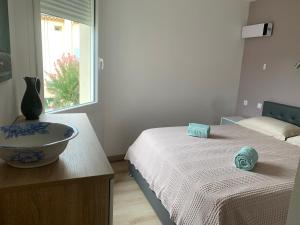 a room with two beds and a bowl on a table at Escapade Vallée du Doux in Tournon-sur-Rhône +4 photos