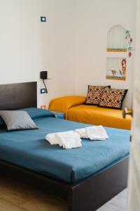 two beds with towels on top of them in a room at Timbuktu Hostel in San Vito lo Capo +101 photos