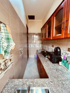 a kitchen with a sink and a counter top at Makali Private Villa- 2En-Suite Bedrooms in Arusha