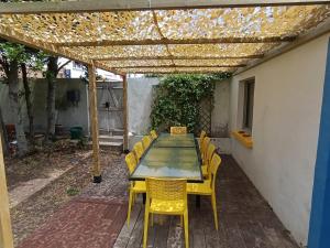 a patio with a table and chairs under a pergola at Les Bains in La Guérinière +35 photos