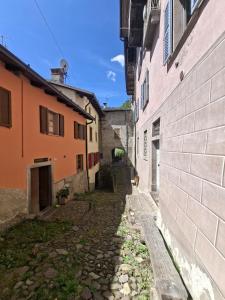 an alley in an old town with buildings at ALBERGO DIFFUSO ORNICA NEL CUORE in Ornica +31 photos