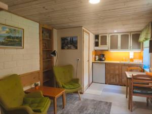a kitchen with two chairs and a table in a room at Pärna Guesthouse & Apartments in Kuressaare