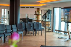 a waiting room with chairs and a flat screen tv at Staycity Aparthotels Dresden City Centre in Dresden
