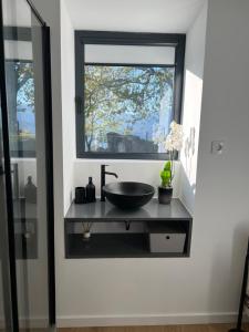 a bathroom with a sink and a window at Refúgio do Saltadouro - Entre o Gerês e a Cabreira in Ruivãis +15 photos