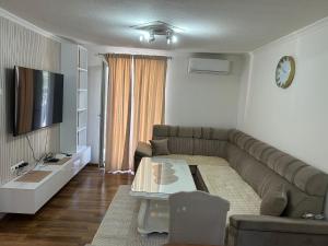 a living room with a couch and a table at Home DINA in Ilidža