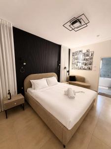 a bedroom with a large white bed and a couch at Villa Naama in Qasrîne +24 photos